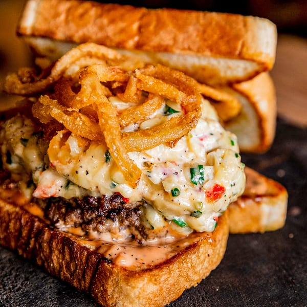 Gettin' Basted's BBQ burger with creamy sauce, crispy fried onions, and toasted bread.