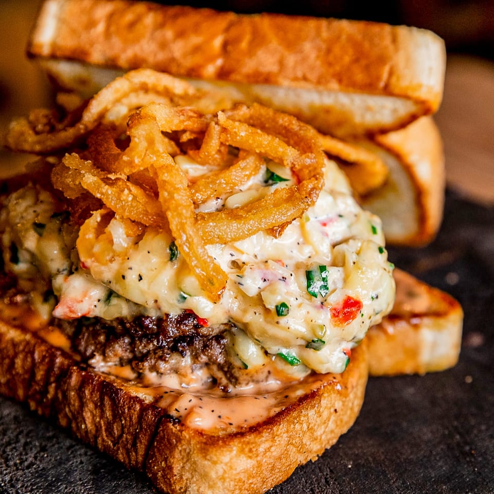 Gettin' Basted's BBQ burger with creamy sauce, crispy fried onions, and toasted bread.